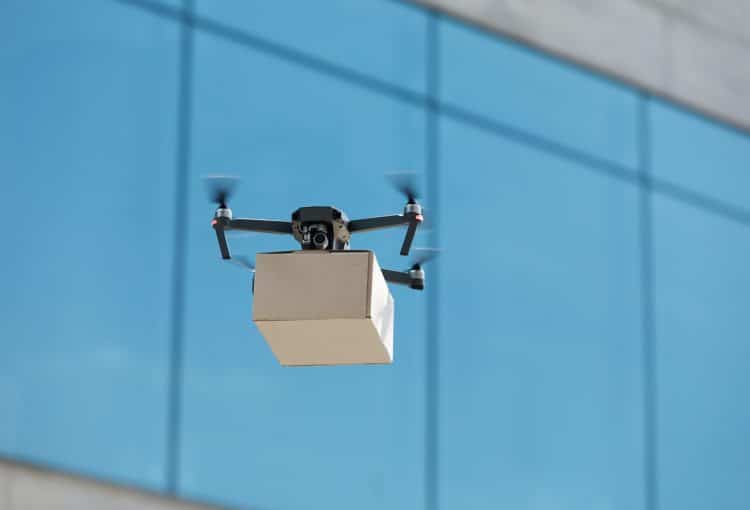 Innovation drone fast delivery concept, drone with cardboard parcel