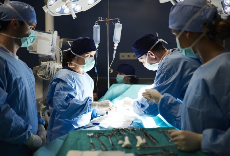 Group of busy surgeons over the operating table