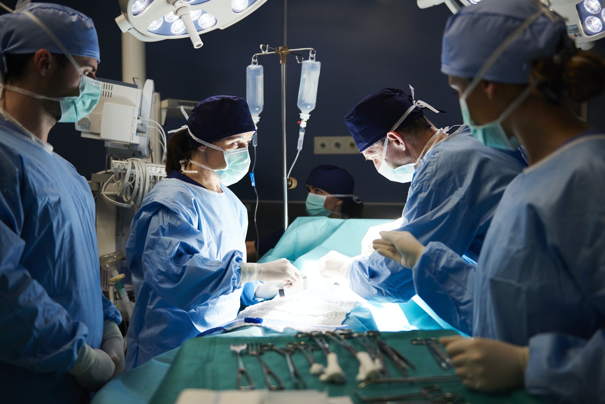 Group of busy surgeons over the operating table