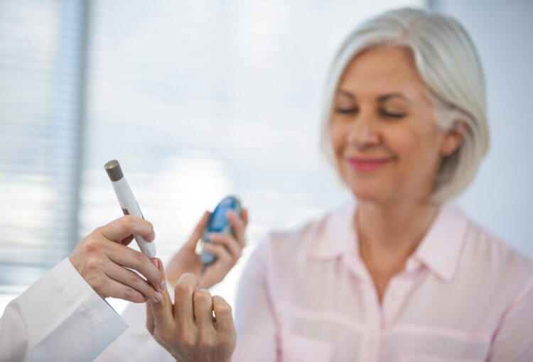 Doctor checking glucose level in diabetic patient